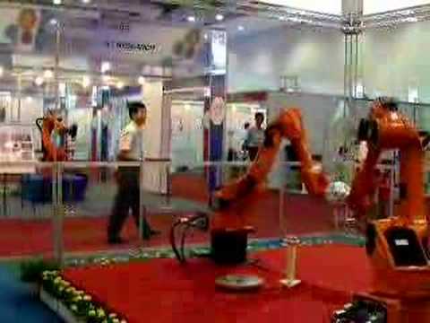 Industrial Robots handling a soccar ball